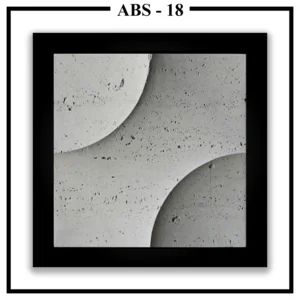 A close-up of a square Luxture Abstract ABS-18 wall panel with two opposing curves and a rough, travertine-like texture.
