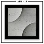 A close-up of a square Luxture Abstract ABS-18 wall panel with two opposing curves and a rough, travertine-like texture.