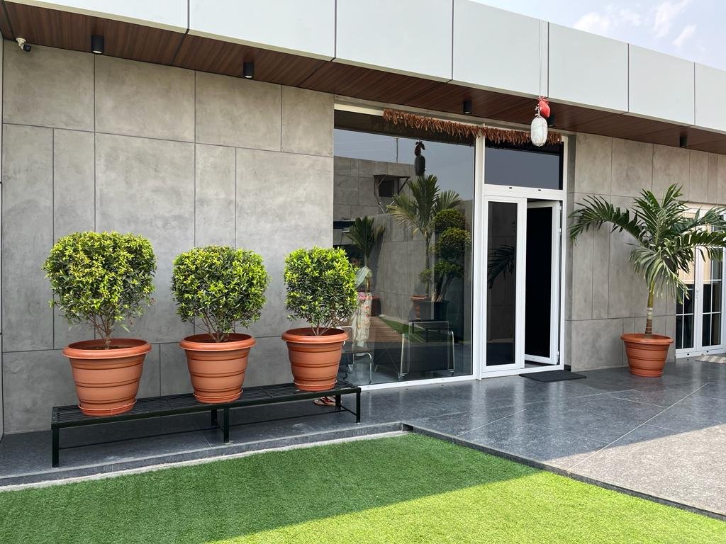 Products 5 Modern building exterior featuring Luxture's Concrete Facades and potted plants.
